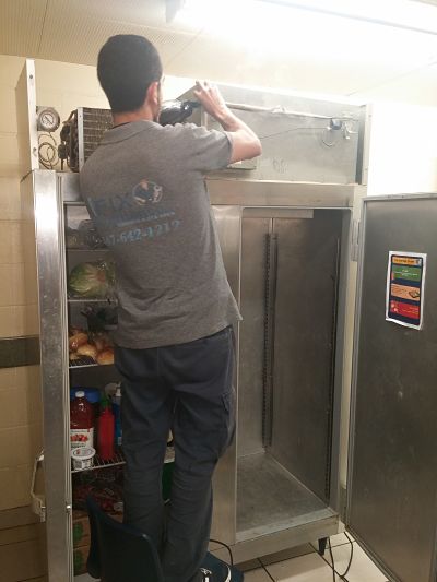 commercial Refrigerator Repair specialist fixing commercial fridge