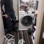 dryer repaired on top of washer in a laundry room - amana dryer repair