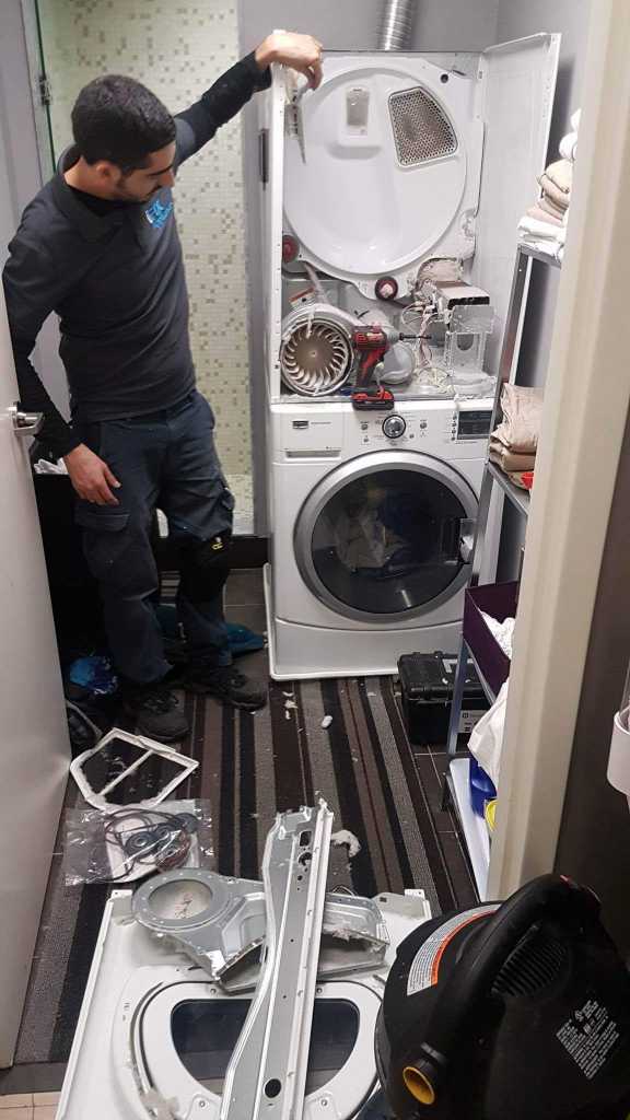 dryer repaired on top of washer in a laundry room - squeaky dryer fix
