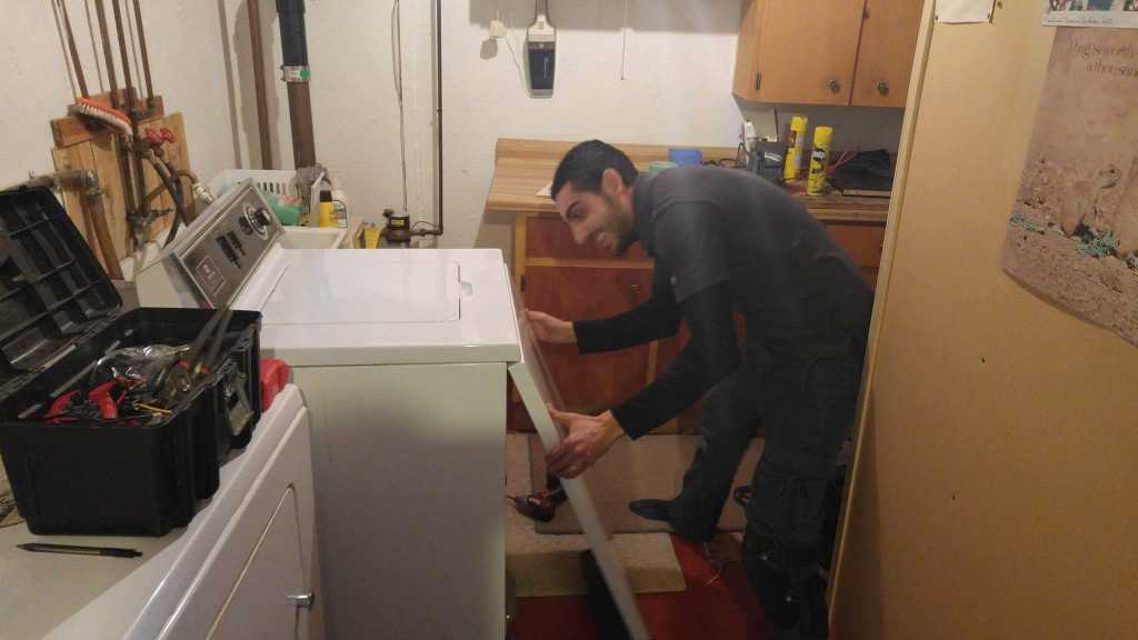 old model washer repair in a basement