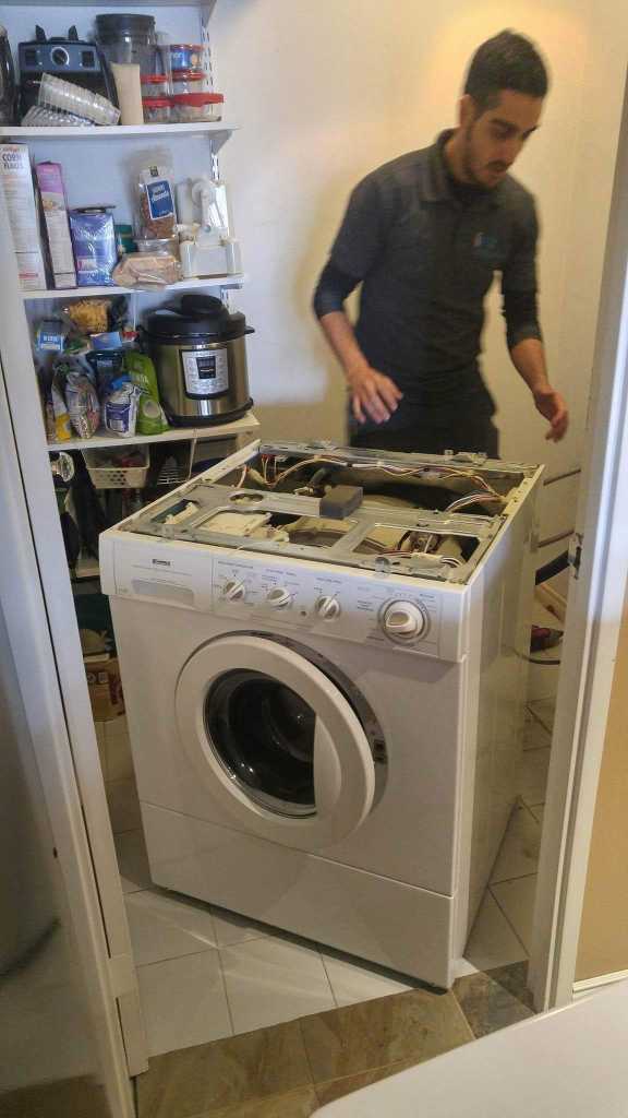 ifix appliance repair technician fixing a washer