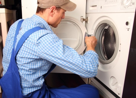 Washer Repair technician fixing a washing machine