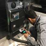 a technician fixing a dishwasher appliance