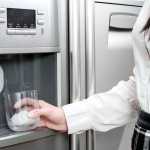 Image of a girl using a fridge ice dispenser